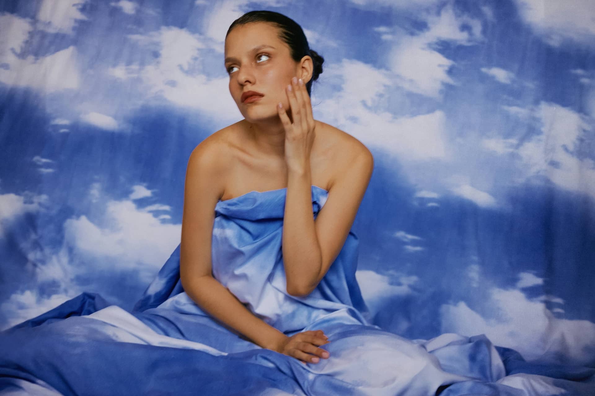 What is Editorial Photography Portrait Candid Photography Woman with Sky Backdrop